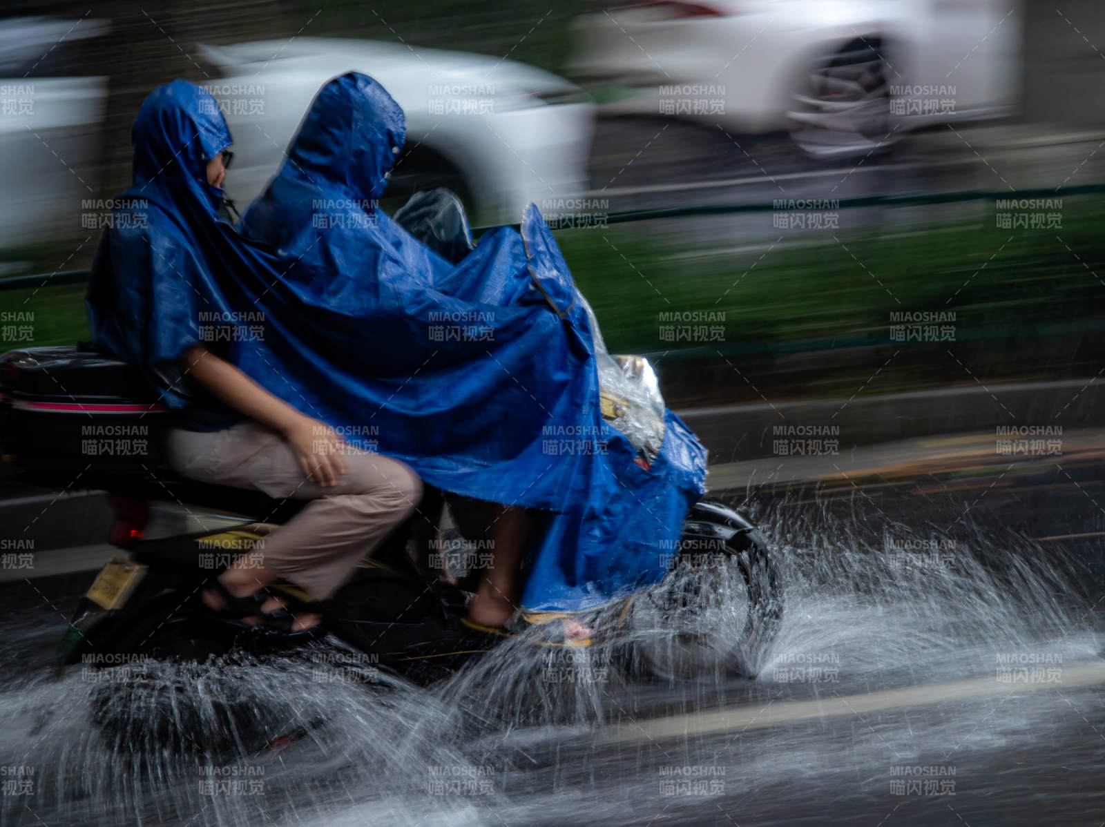 雨中騎行 藍色雨披相伴