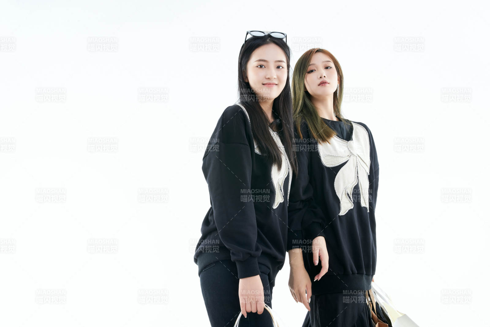 白色背景下手提購物袋時尚美麗的閨蜜