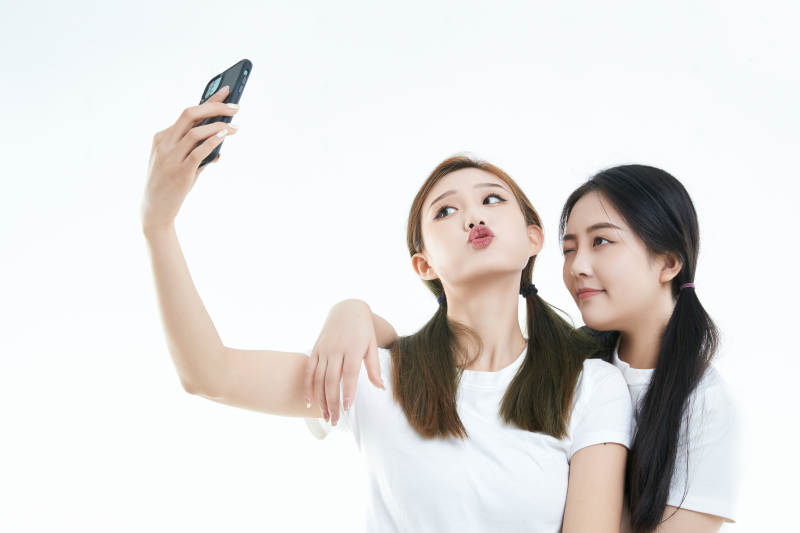 使用手机自拍的亚洲可爱闺蜜少女