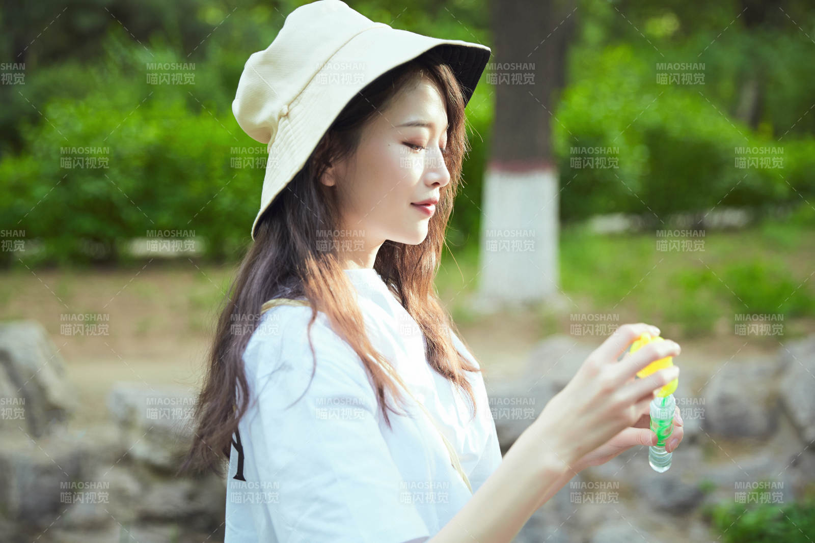 戶外公園里玩吹泡泡的可愛亞洲少女