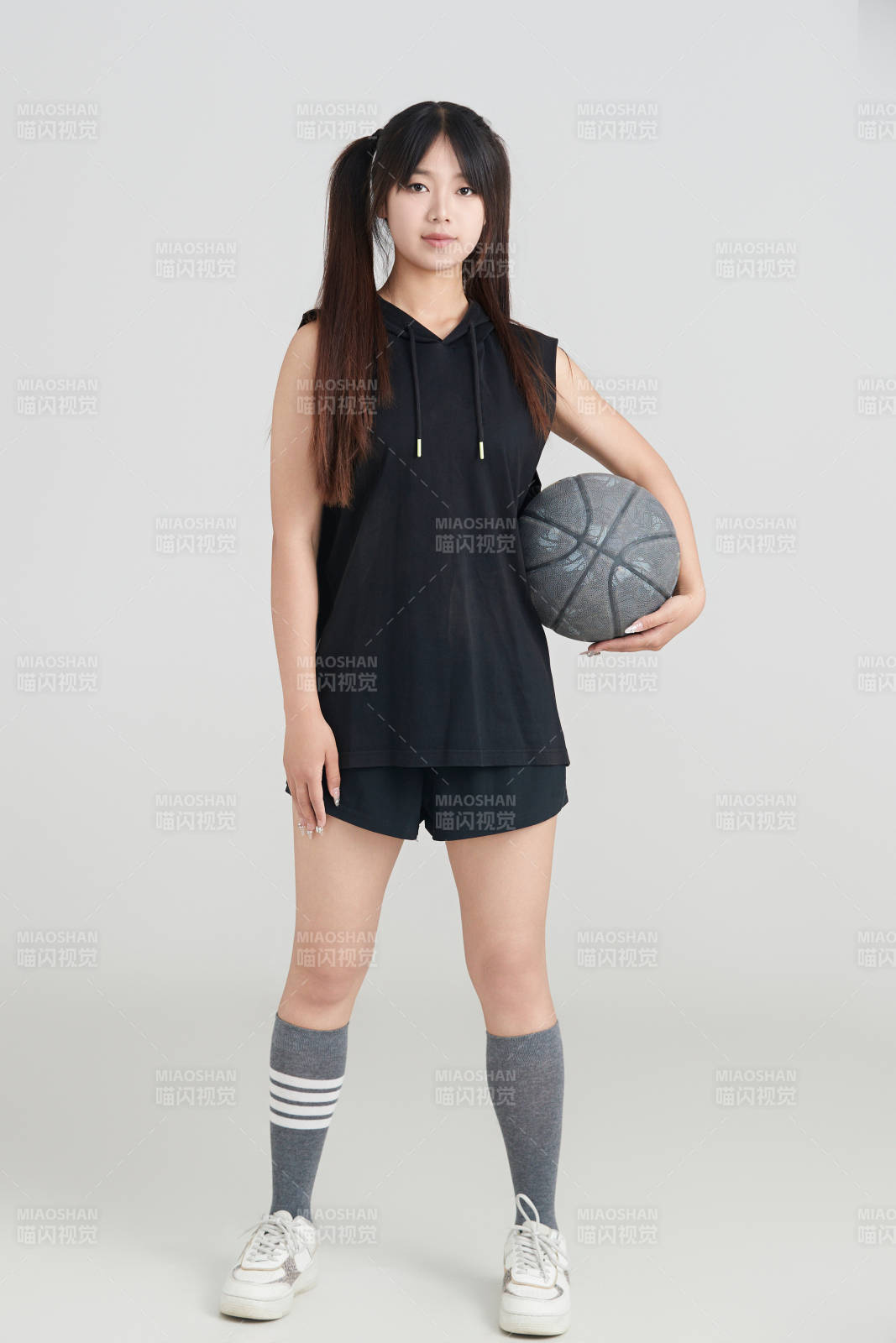 白色背景下的年轻女孩和篮球