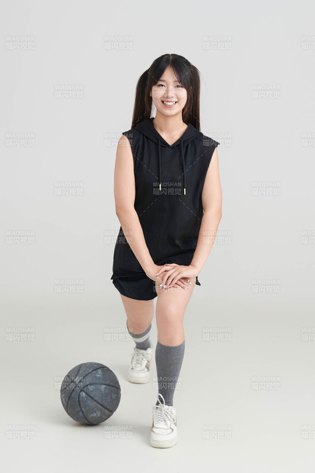 白色背景下的年轻女孩和篮球