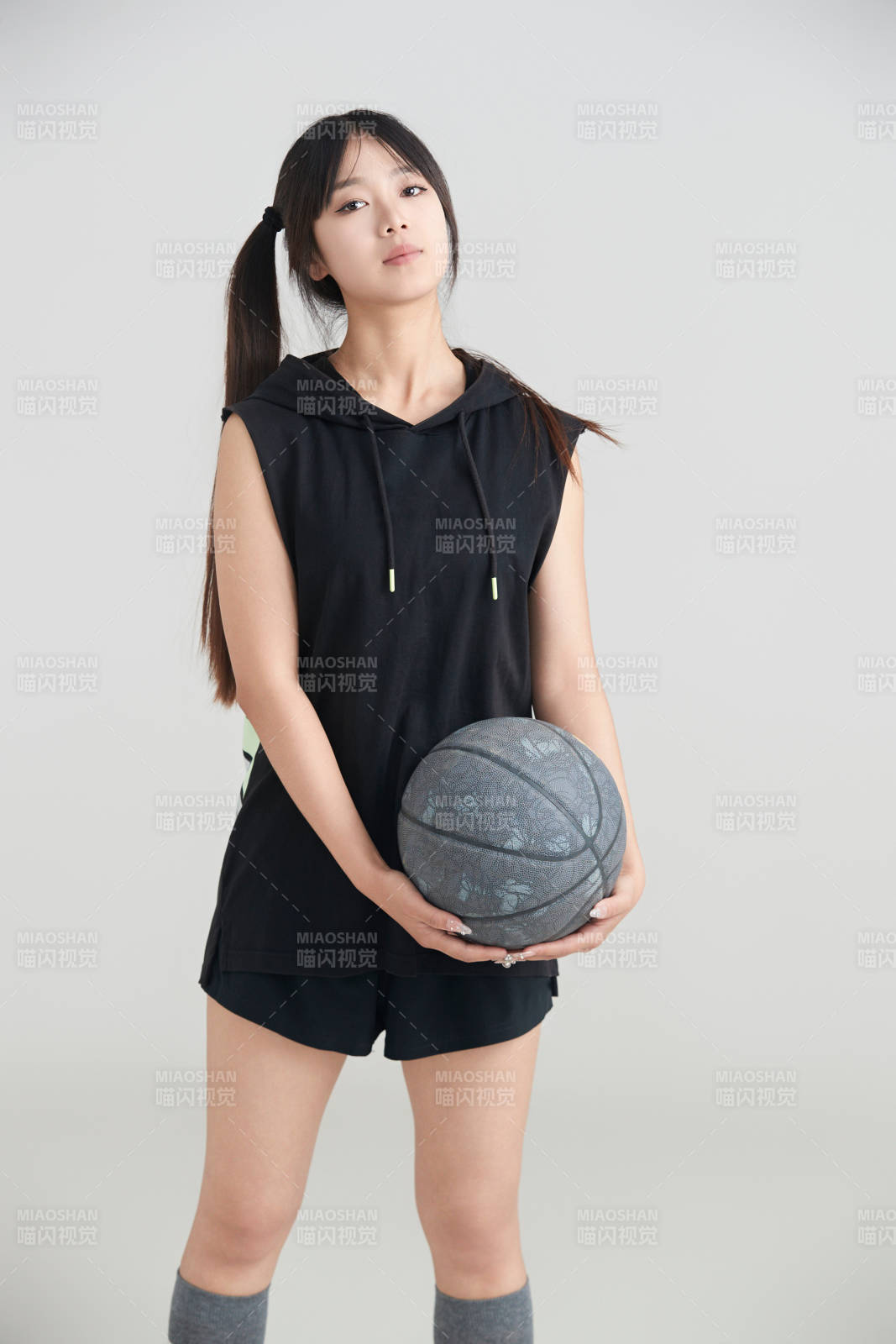 白色背景下的年轻女孩和篮球