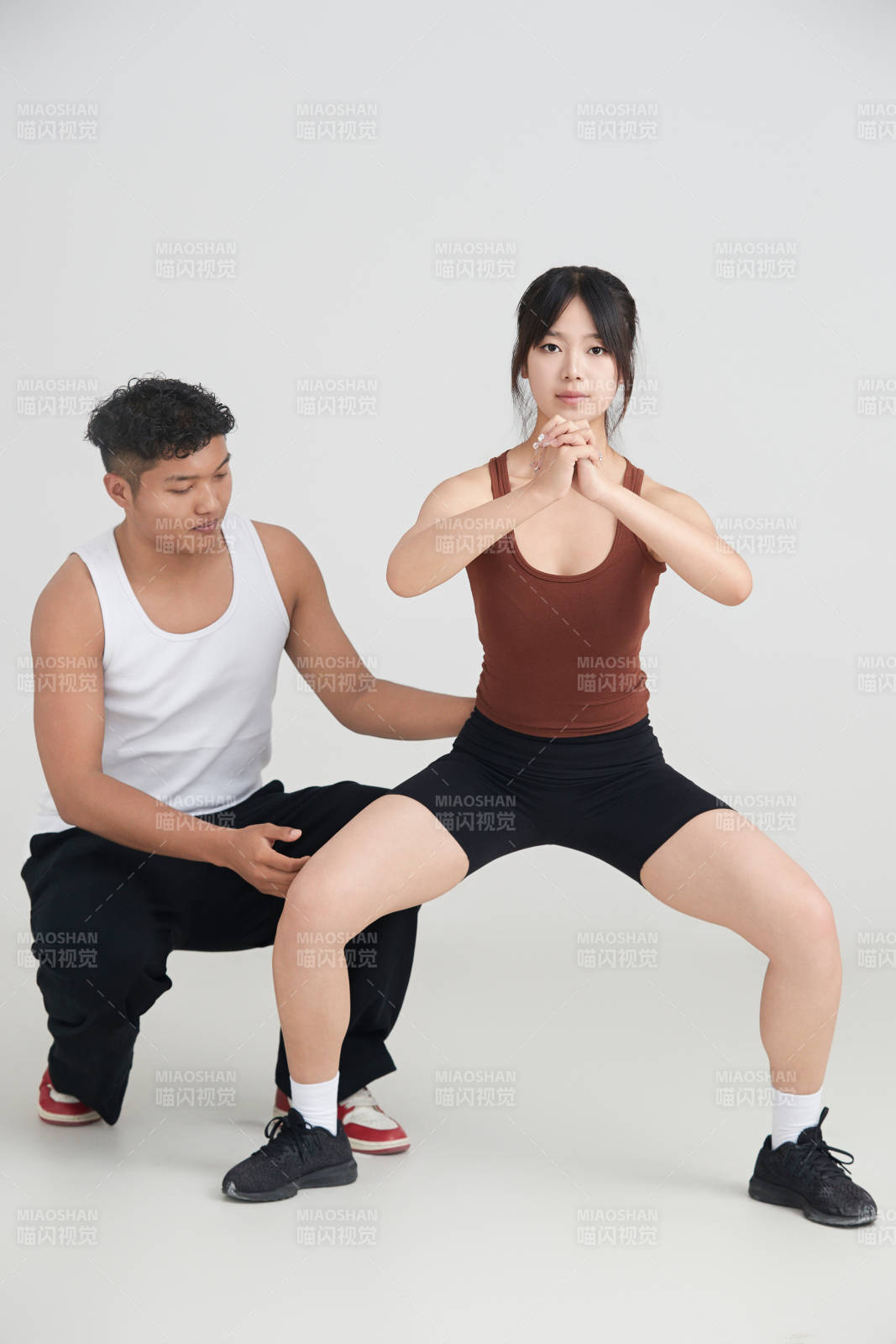 年輕女子在教練的指導下健身