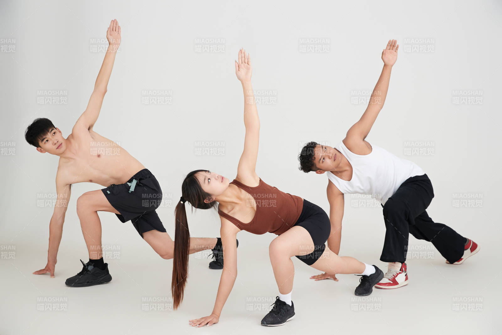 兩名年輕男子在美女教練的帶領(lǐng)下做健身操