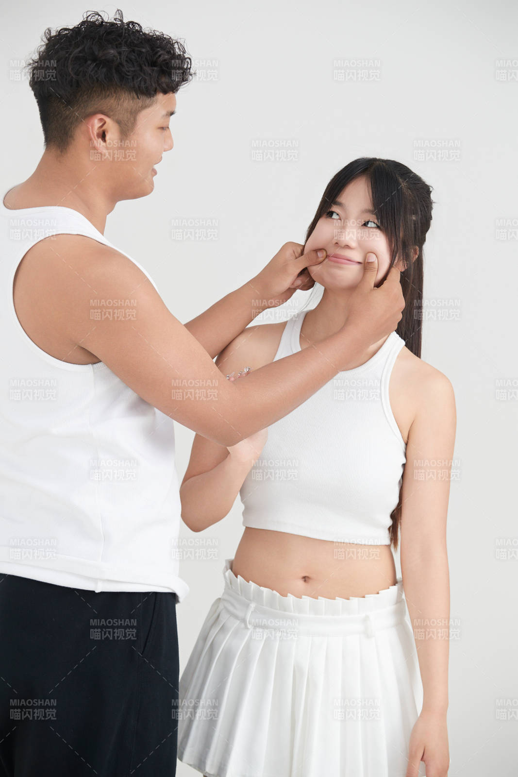 白色背景下嬉戲歡樂的亞洲情侶