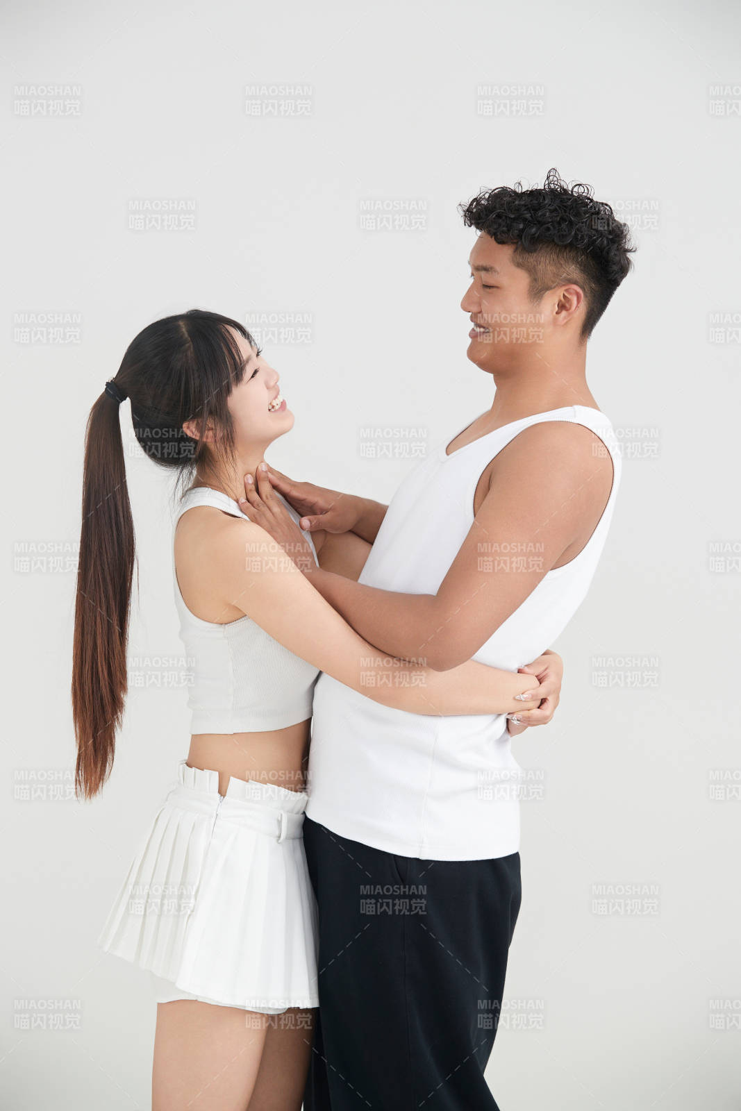 白色背景下嬉戲歡樂的亞洲情侶
