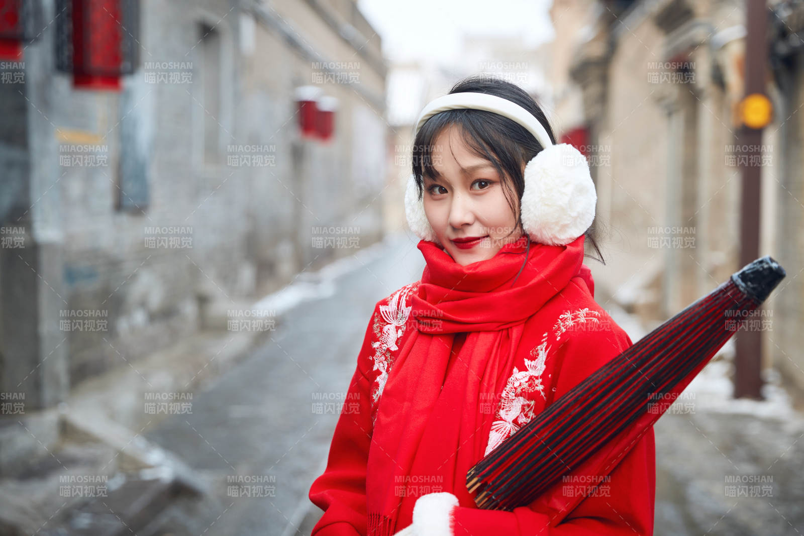 雪后在老城古巷穿著喜慶服飾的亞洲少女