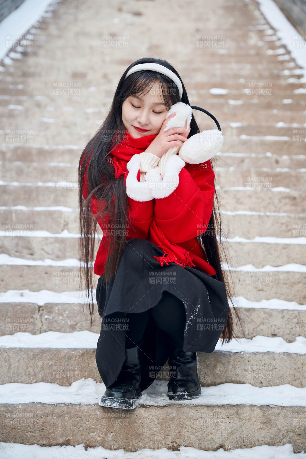 雪后在老城古巷穿着喜庆服饰的亚洲少女