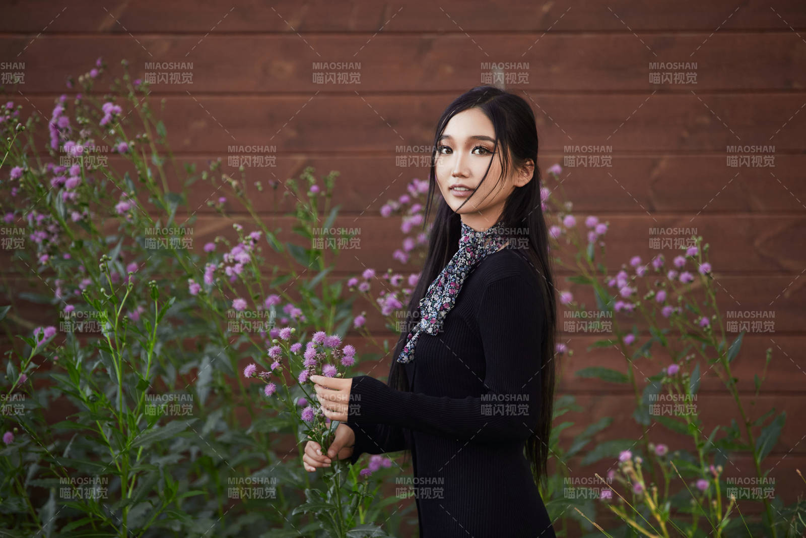 盛夏夕陽照射下花叢草地中的亞洲美女