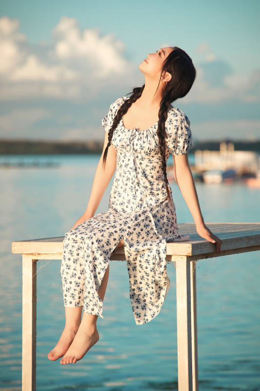 夏日湖畔水边游玩拍照的亚洲美女