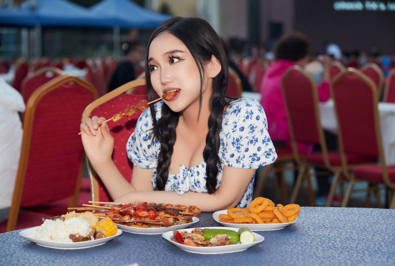 在户外冷餐自助餐会大吃特吃的美女