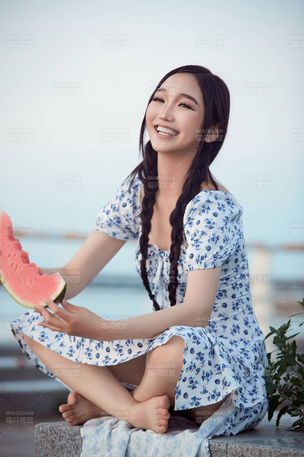 夏天在公园湖边开心吃西瓜的美女