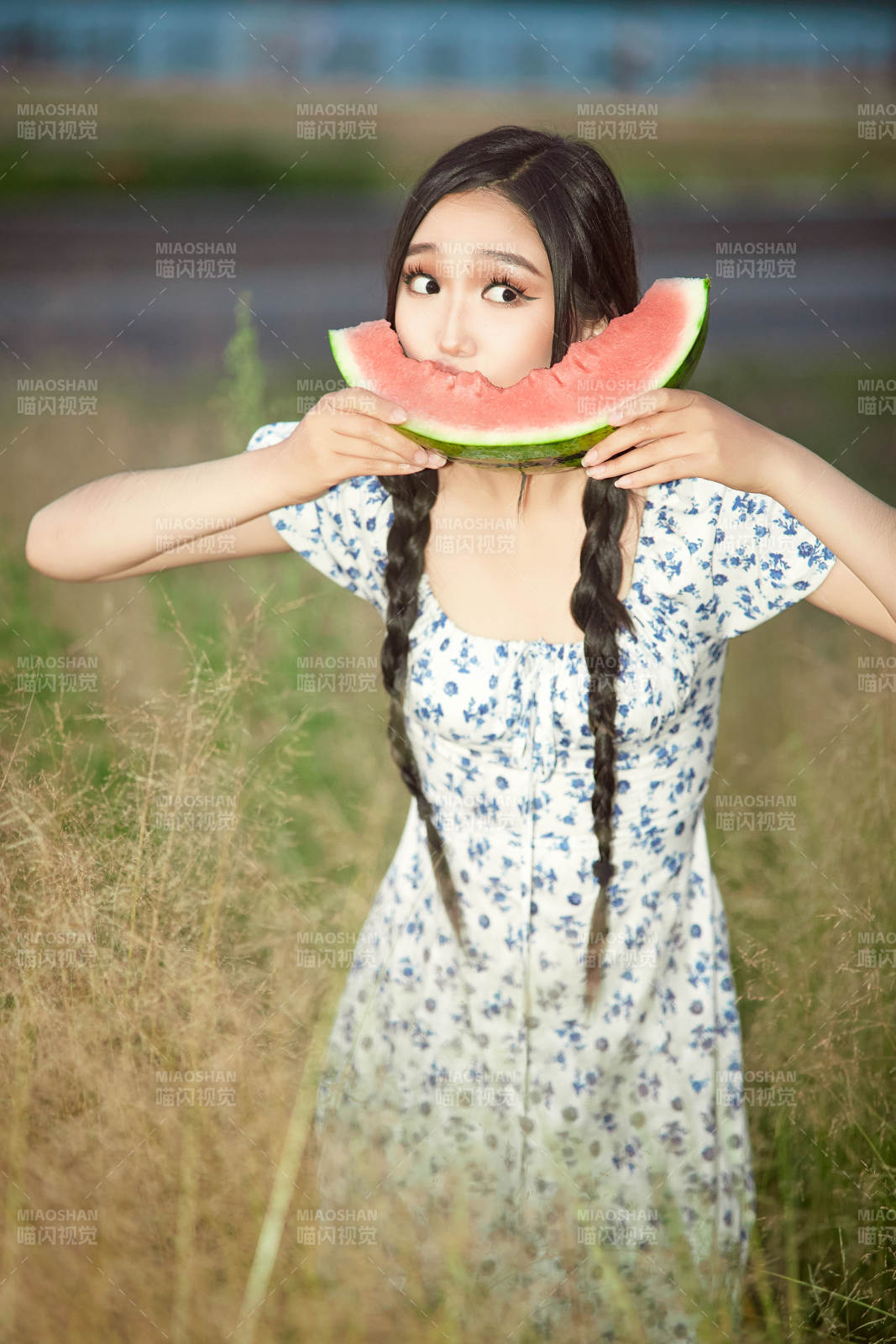 夏天在公园湖边开心吃西瓜的美女