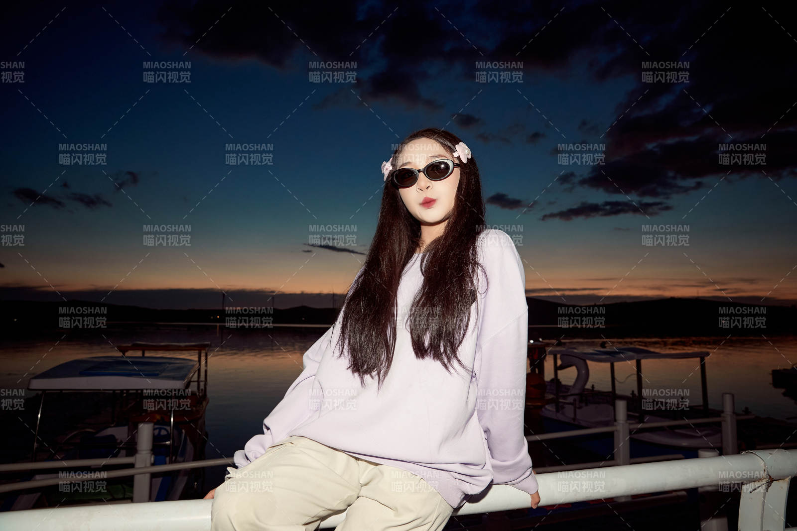 傍晚在湖邊欣賞風景拍照的亞洲美女