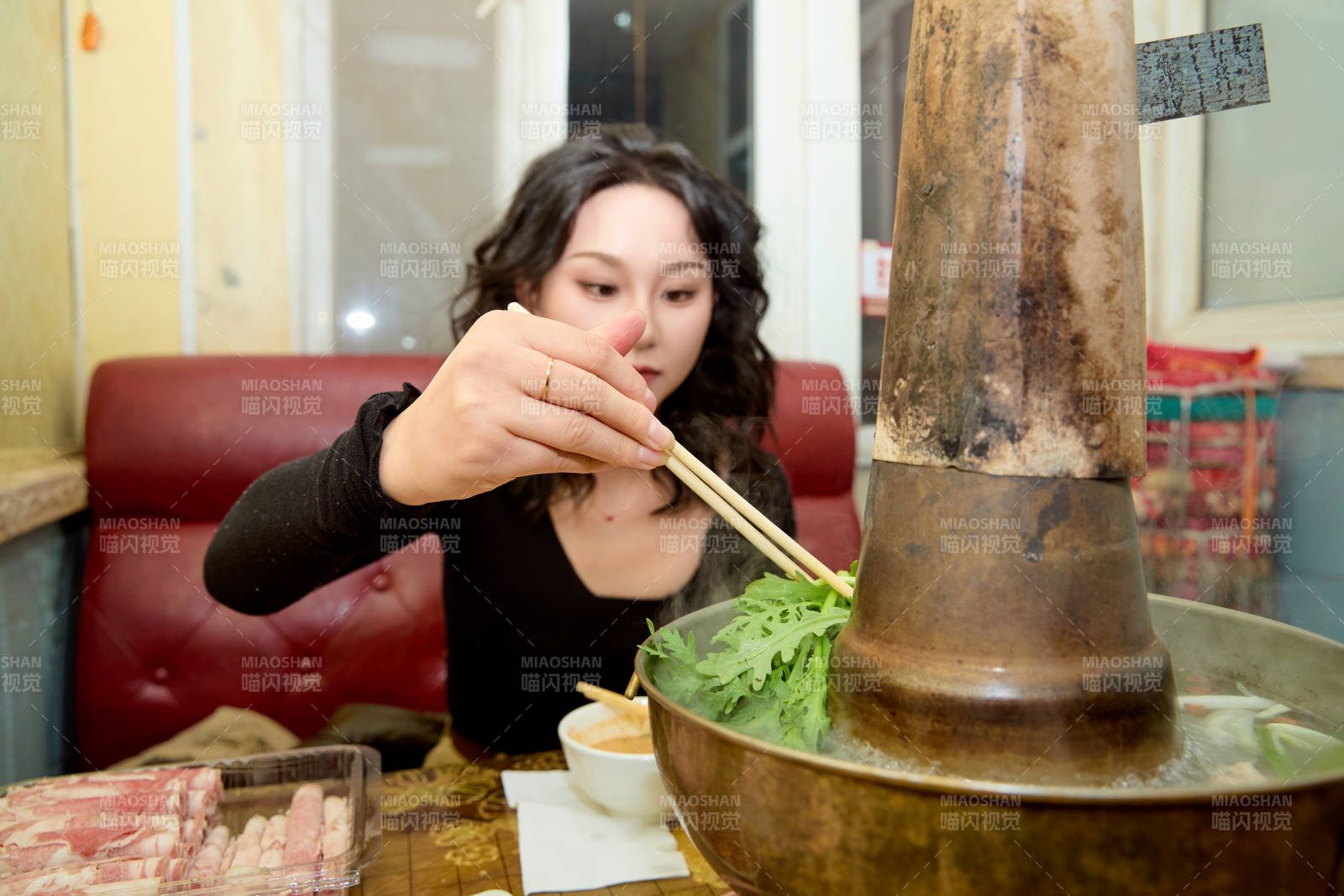 飯店吃傳統(tǒng)銅鍋涮肉的東方美女