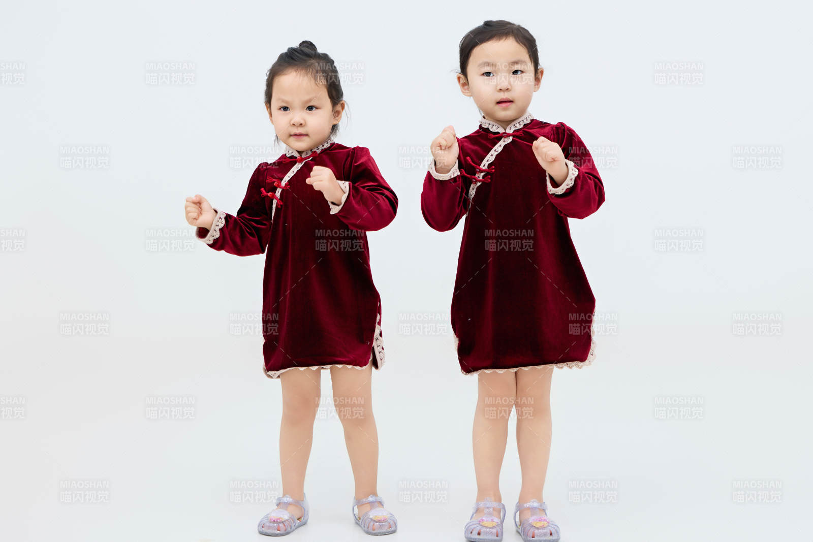 白色背景下頑皮可愛的雙胞胎小女孩