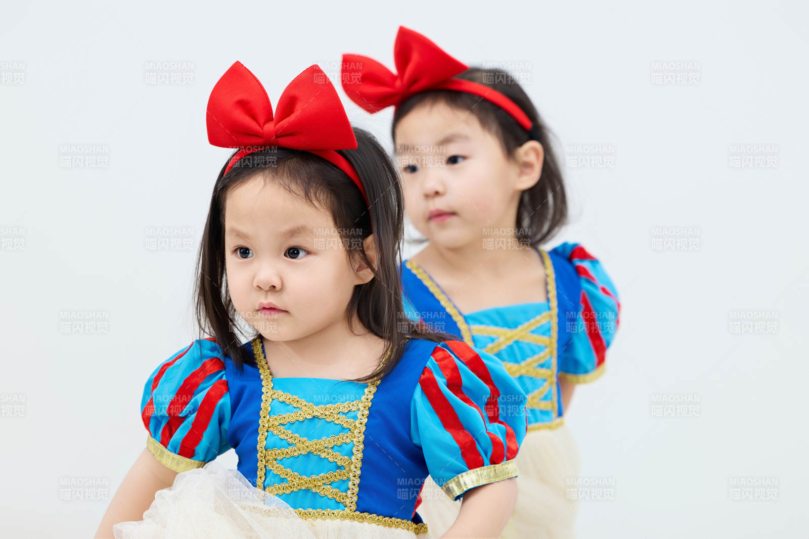 白色背景下頑皮可愛的雙胞胎小女孩