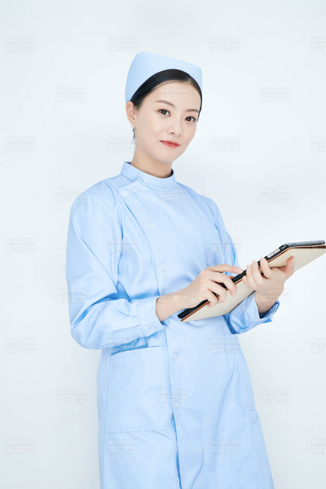 身穿護(hù)士服手拿醫(yī)用iPad的年輕護(hù)士