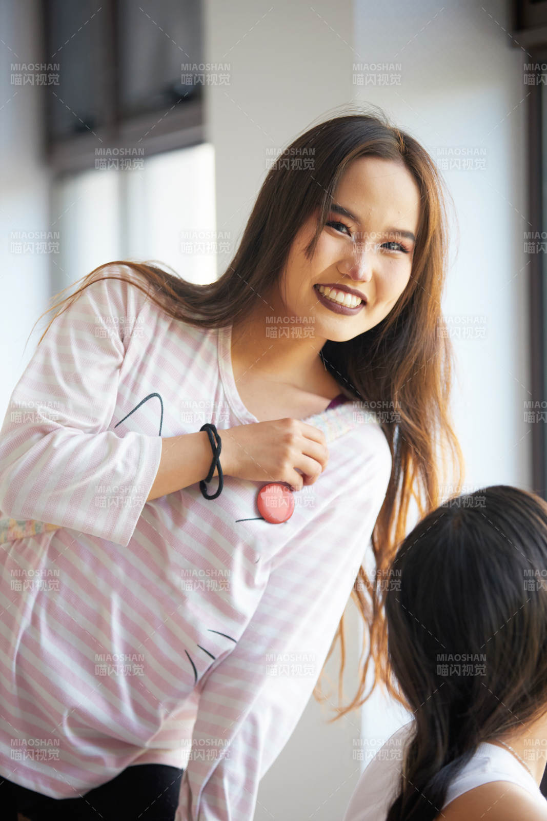 在室内冲着镜头微笑的蒙古族姑娘