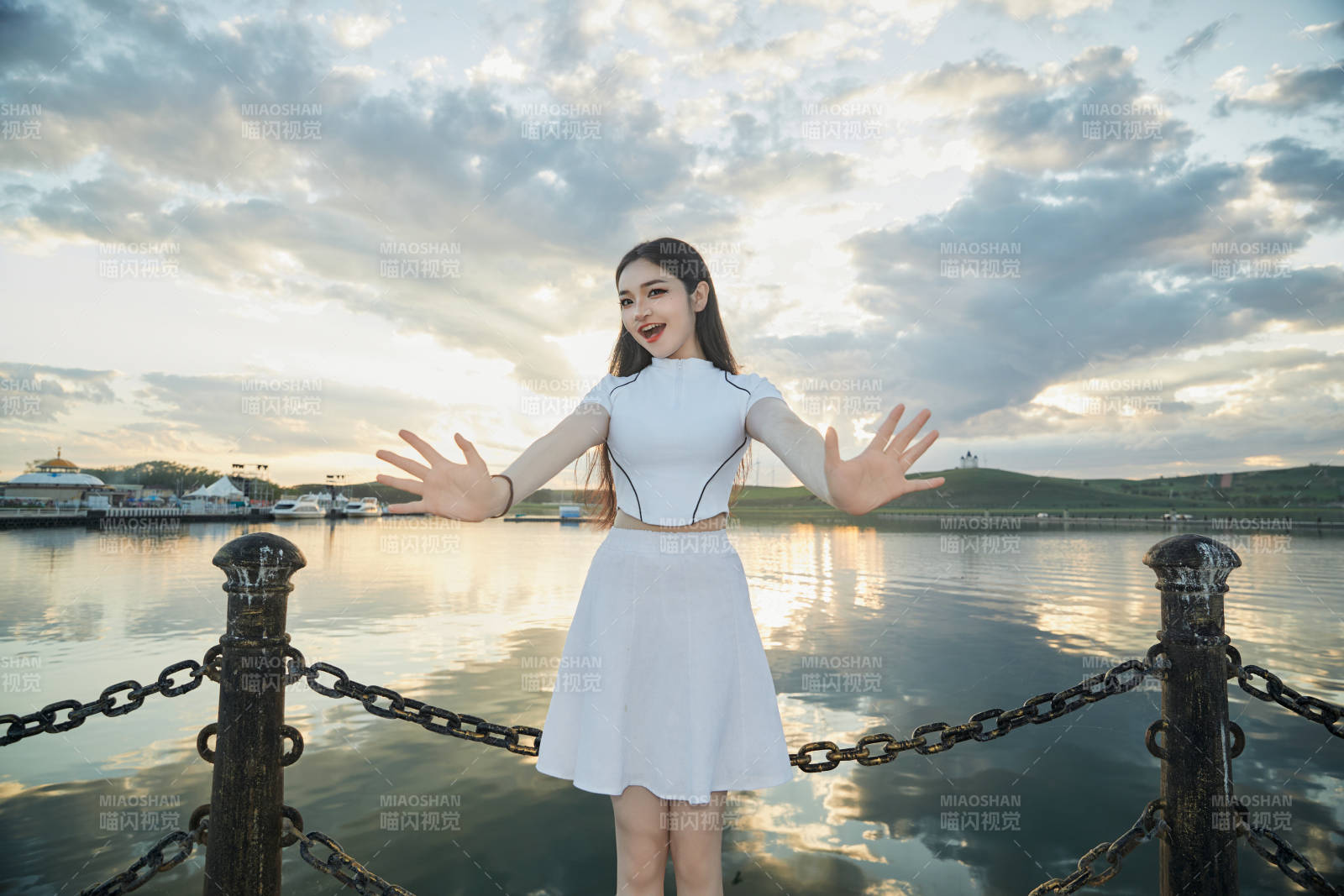 傍晚在湖邊欣賞風景拍照的亞洲美女