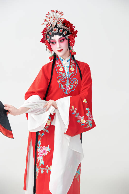 表演中国国粹京剧动作的红衣花旦女性演员