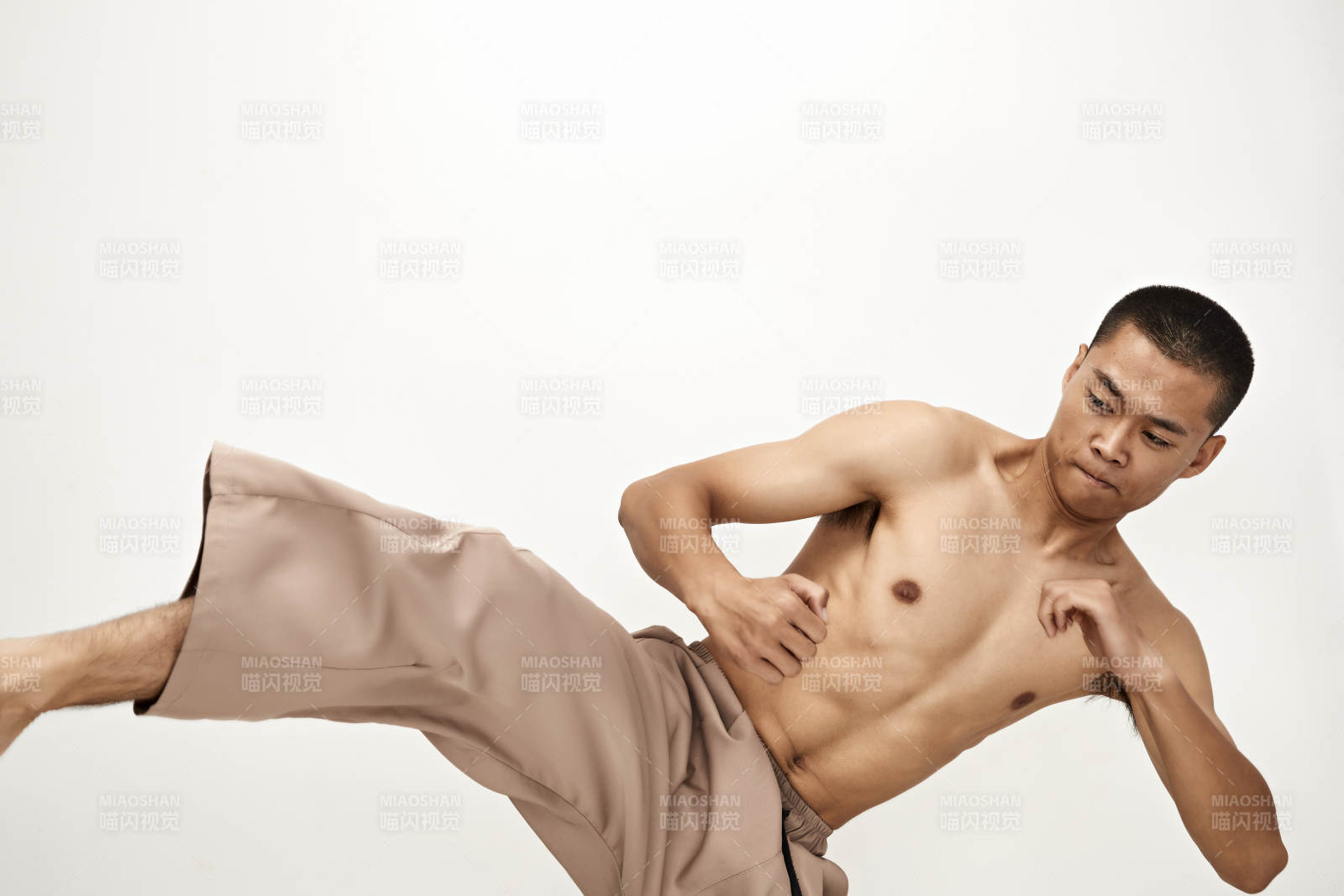 白色背景下演示自由搏擊動作的亞洲功夫男性