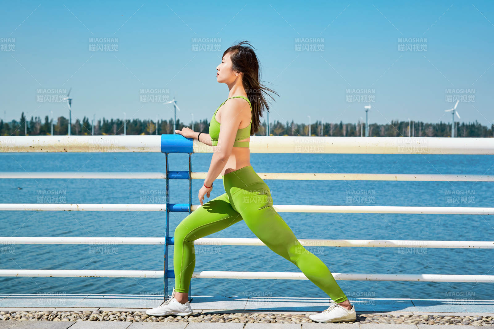 戶外河畔公園做拉伸有氧運動的亞洲女性
