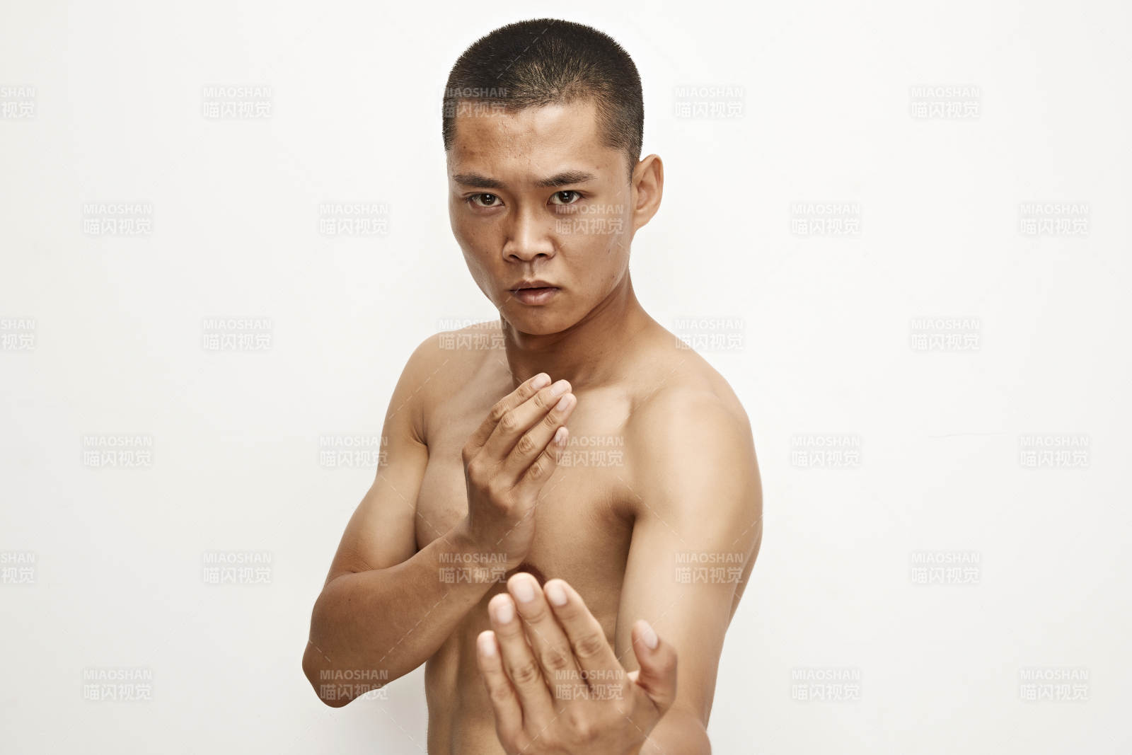 白色背景下演示自由搏擊動作的亞洲功夫男性