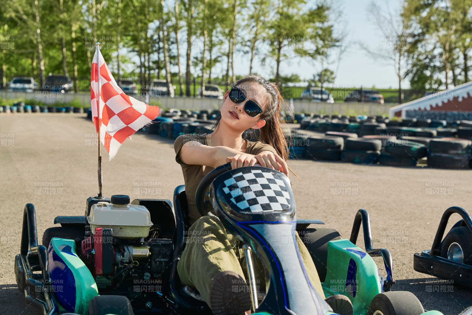 在游乐场卡丁赛道上驾驶卡丁车的美女