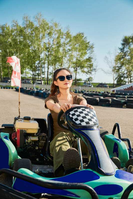 在游乐场卡丁赛道上驾驶卡丁车的美女