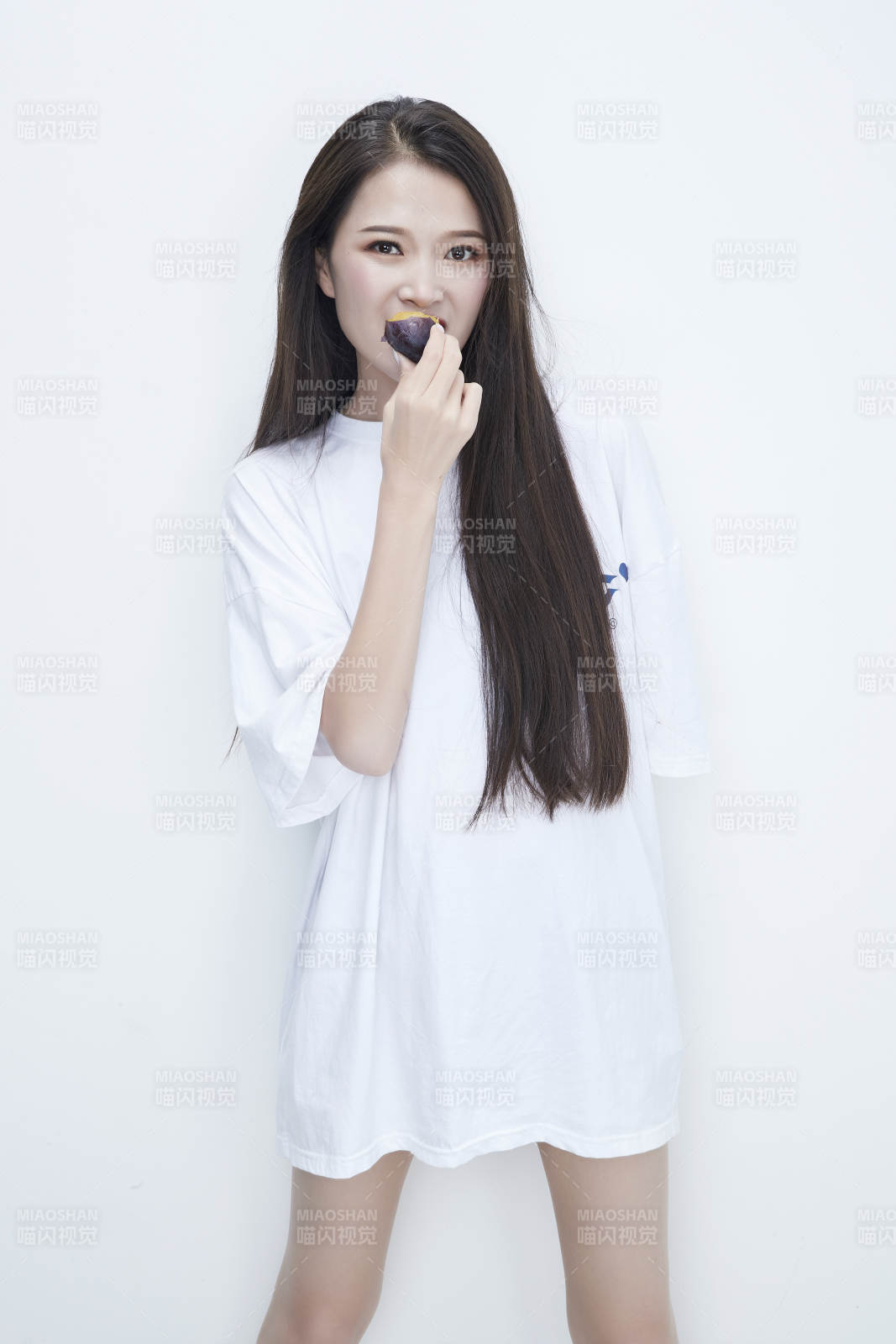 吃西梅的身穿白色長T血襯衫的長發少女人像