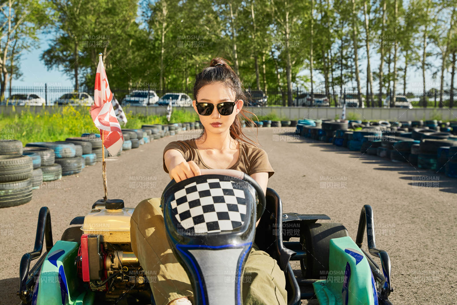 在游樂場卡丁賽道上駕駛卡丁車的美女