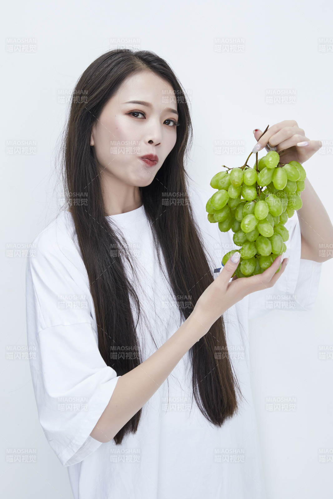 吃葡萄的穿白色長(zhǎng)T血衫的長(zhǎng)發(fā)可愛(ài)少女人像