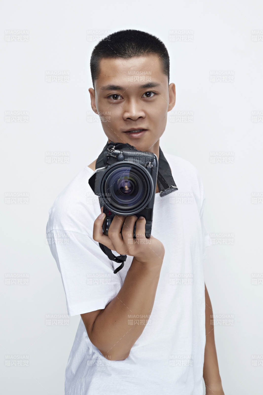 白色背景下手持照相機的亞洲男性攝影師