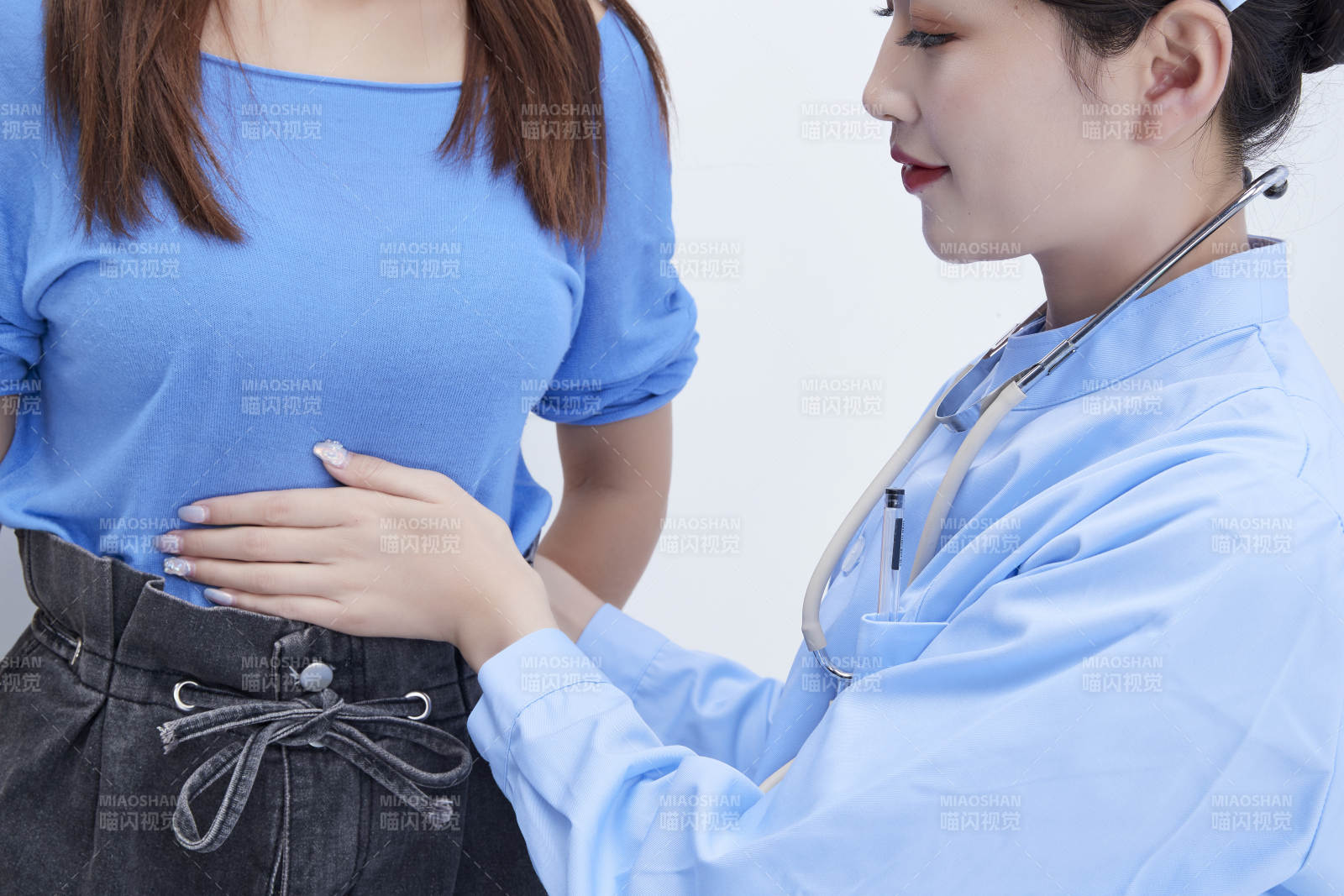 年輕的女性醫(yī)護人員為患者進行身體按壓檢查