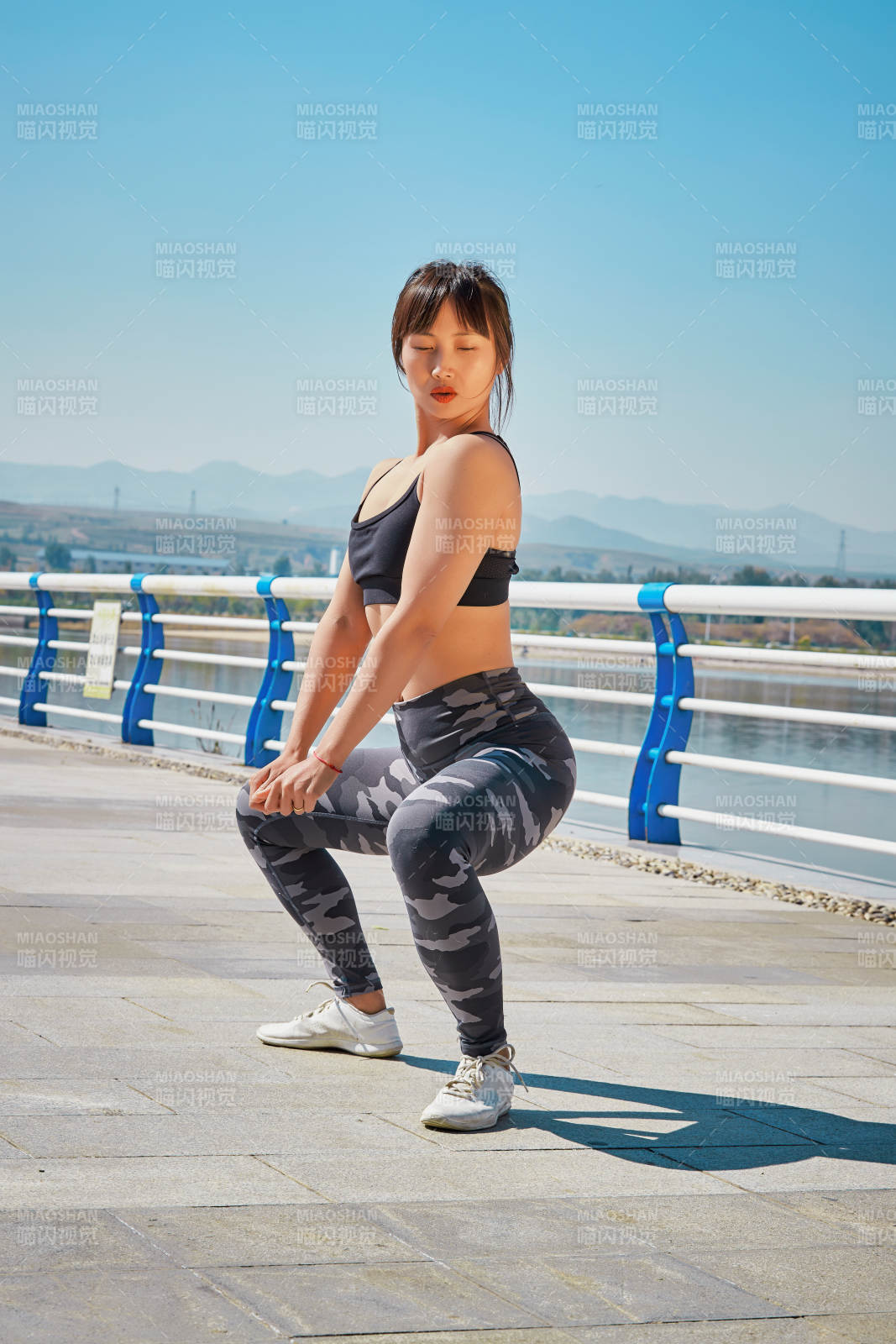 戶外河畔公園做拉伸有氧運動的亞洲女性