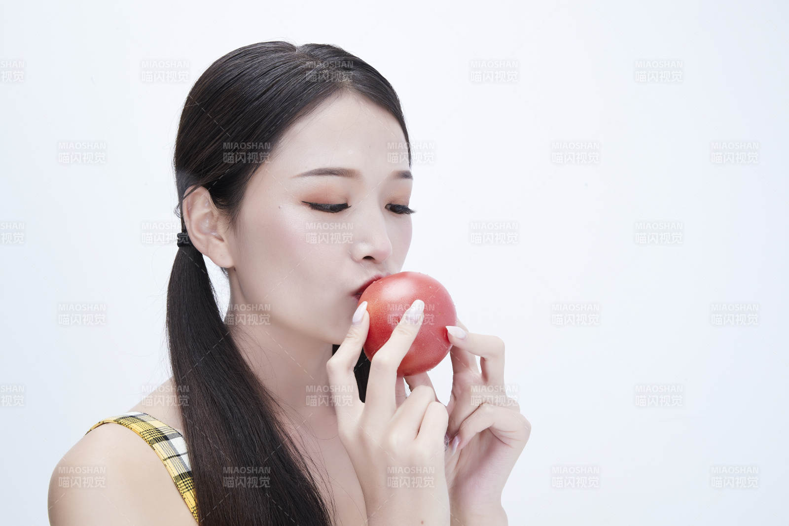 啃咬番茄身穿格子吊帶裙的亞洲可愛少女人像