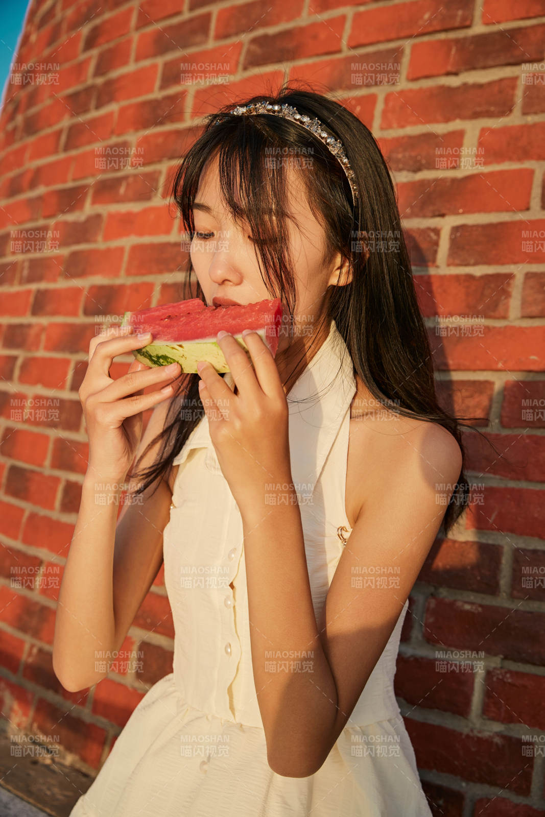 盛夏夕陽湖邊碼頭燈塔上吃西瓜的少女