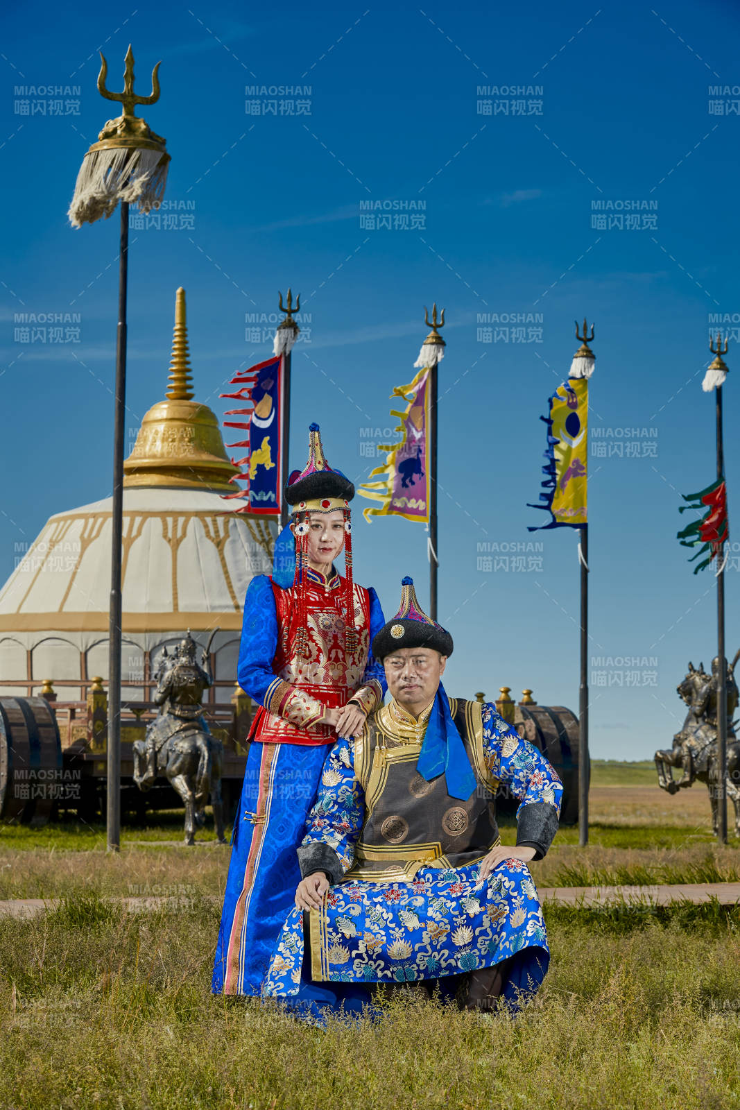 草原上蒙古包前穿蒙古族傳統服飾的年輕夫妻