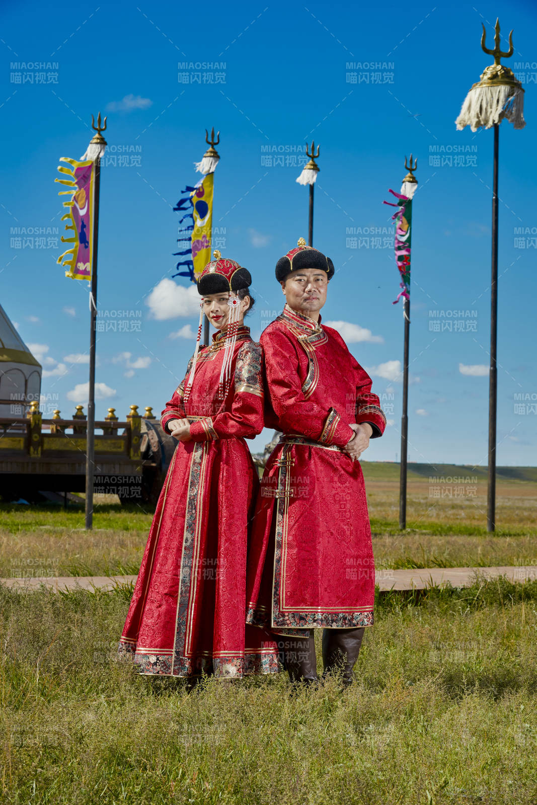 草原上蒙古包前穿蒙古族傳統服飾的年輕夫妻