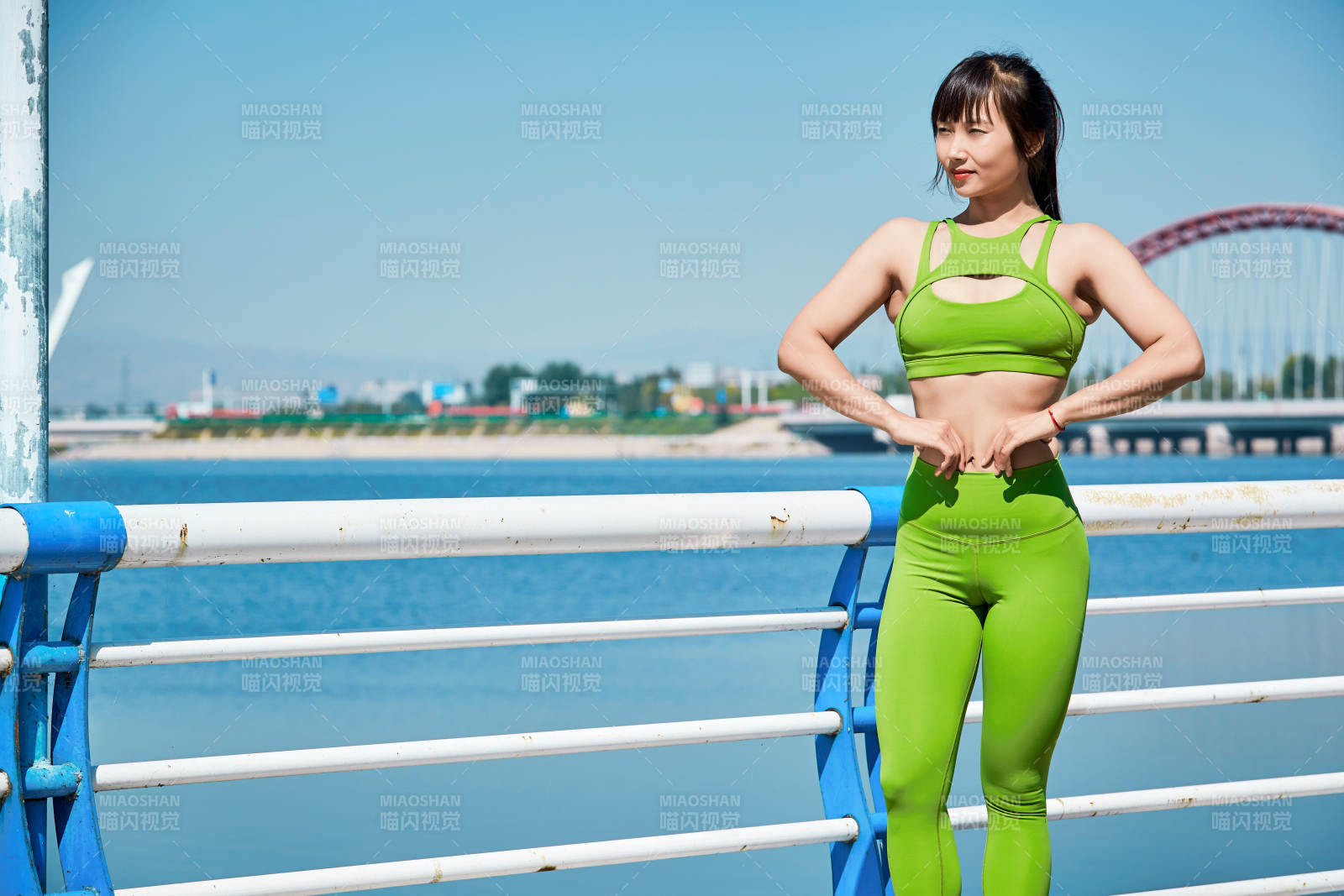 戶外河畔公園做拉伸有氧運動的亞洲女性