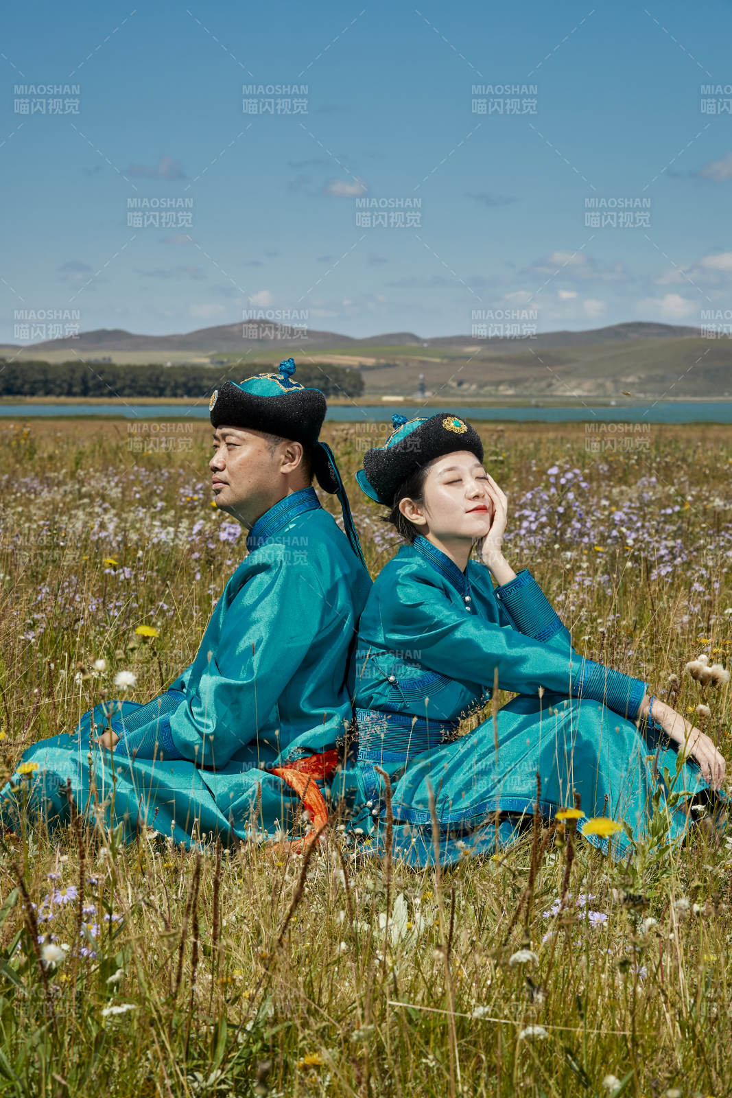 草原上蒙古包前穿蒙古族傳統(tǒng)服飾的年輕夫妻