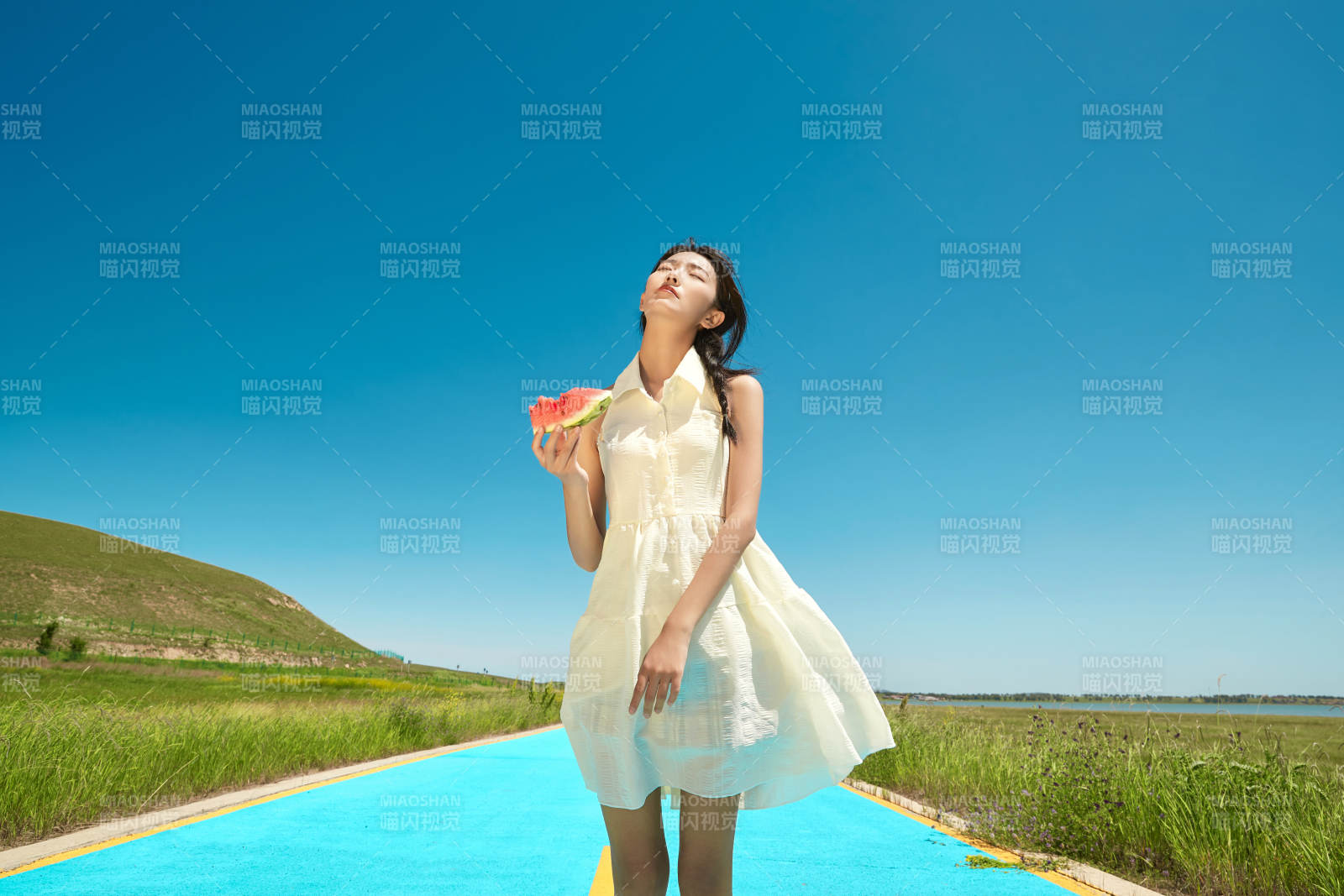 夏日戶外湖邊彩色公路上玩耍吃西瓜的少女