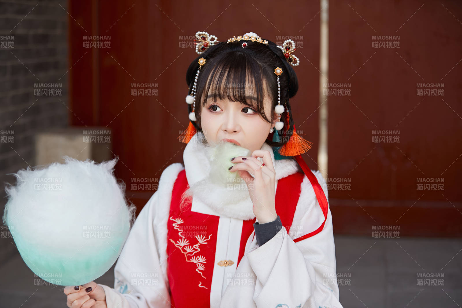 身穿喜慶漢服吃棉花糖的少女