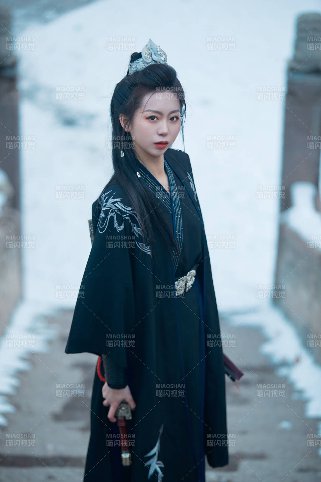 雪天古城身穿漢服扮演武俠的中國少女