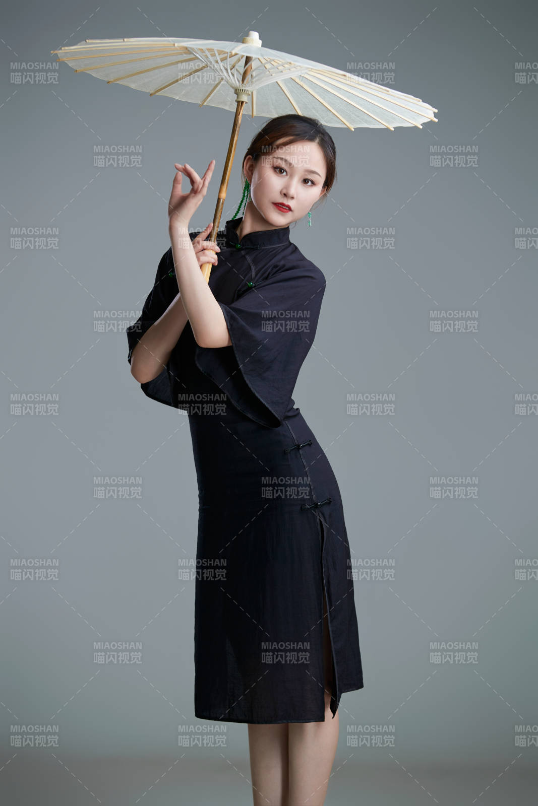 穿中式旗袍手拿油紙傘翩翩舞蹈的亞洲少女舞者