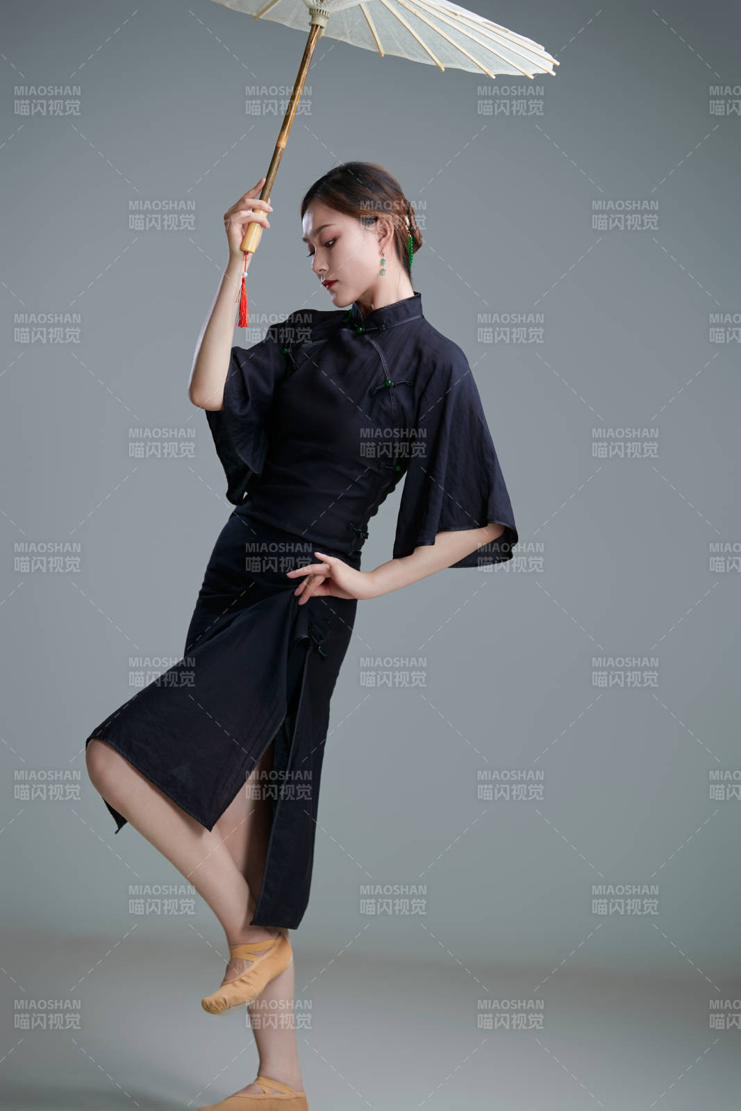 穿中式旗袍手拿油紙傘翩翩舞蹈的亞洲少女舞者