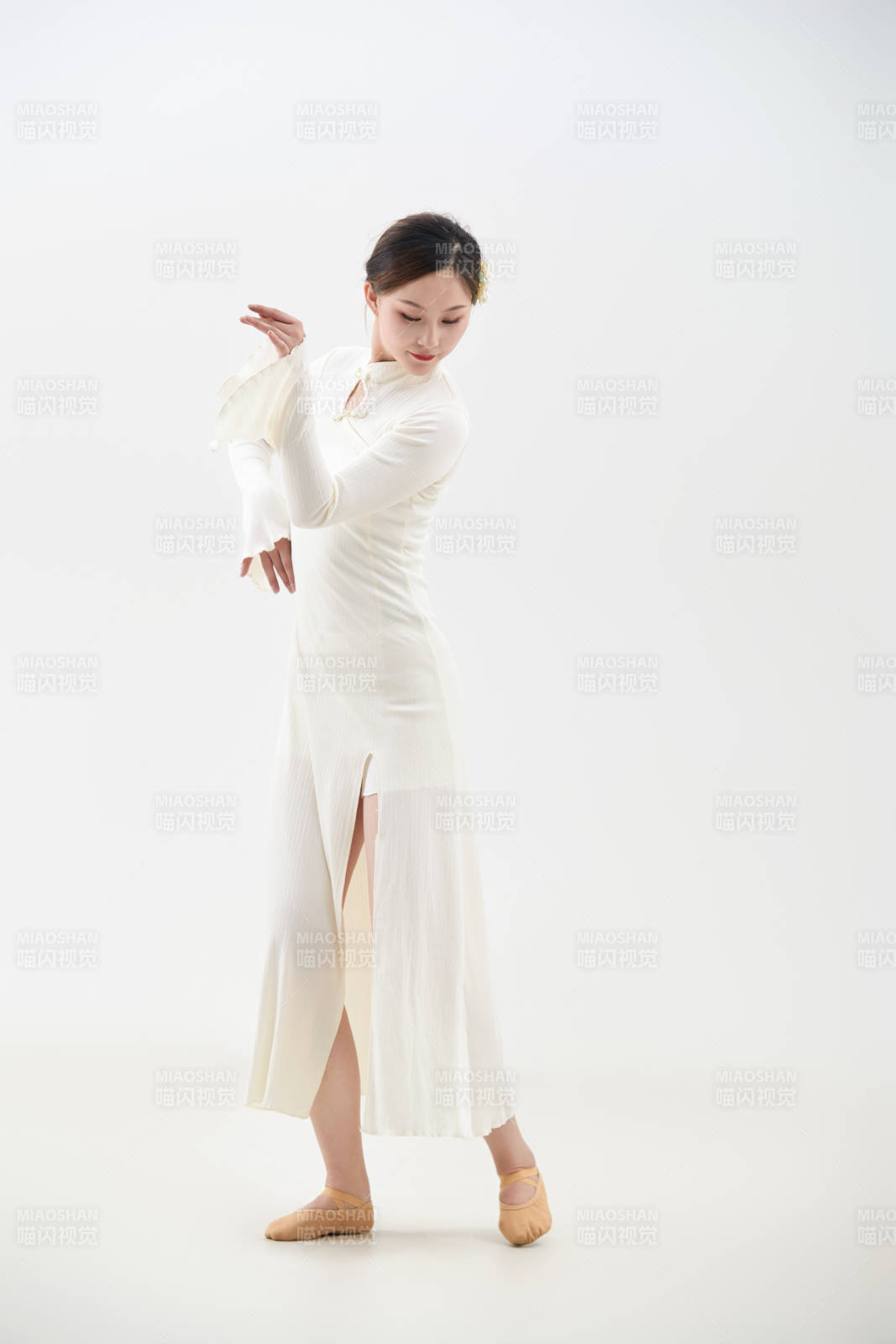 穿著白色旗袍頭戴絹花的跳古典舞的少女