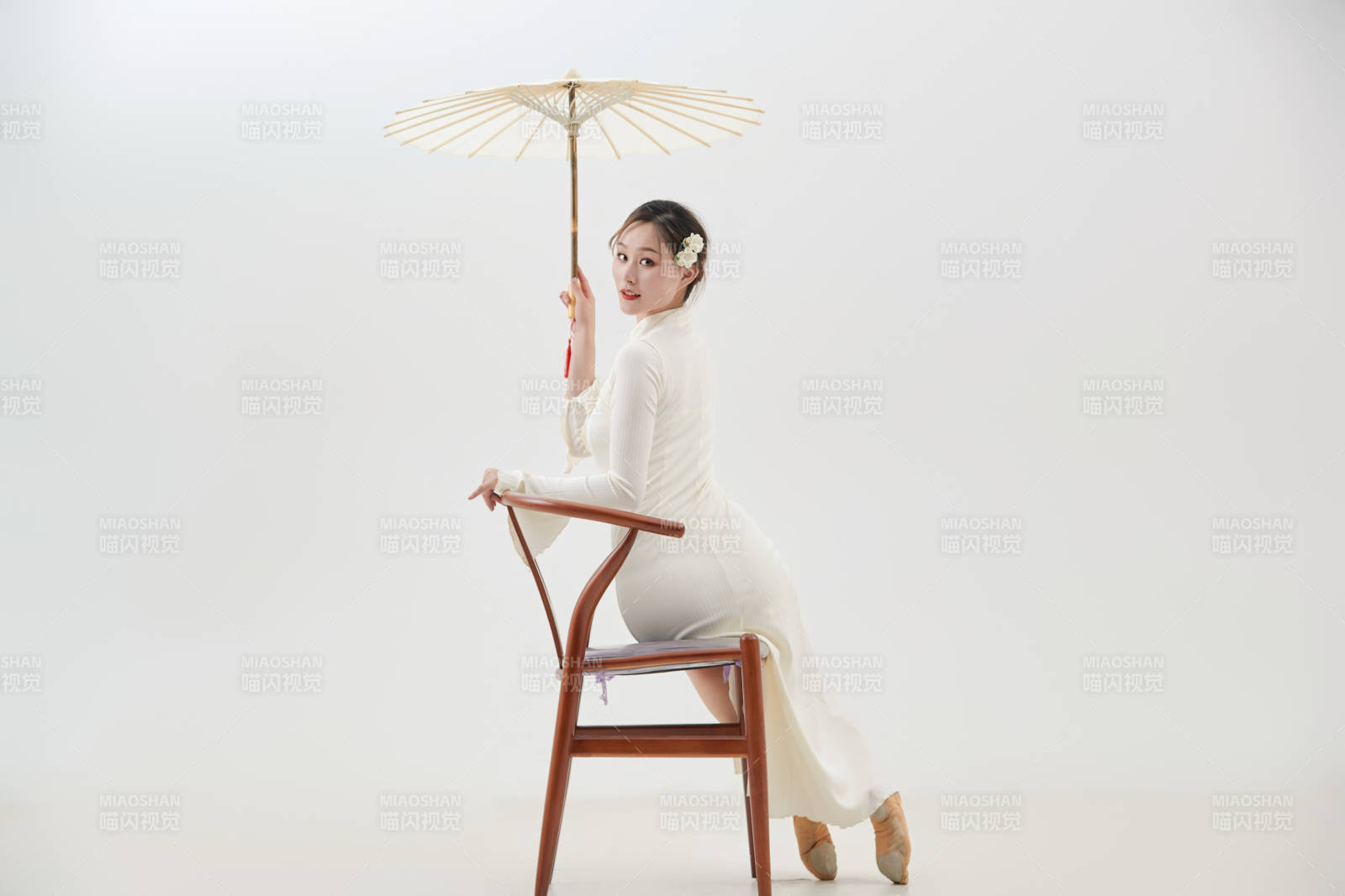 穿著白色旗袍頭戴絹花的跳古典舞的少女